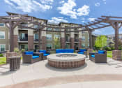 Thumbnail 2 of 41 - an outdoor lounge area with a fire pit in front of an apartment building