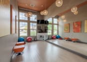 Thumbnail 15 of 41 - a yoga room with large windows and a wood floor