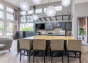 Thumbnail 13 of 41 - an open kitchen with a large island and a dining room table