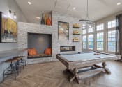 Thumbnail 17 of 41 - a game room with a pool table and a fireplace
