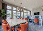 Thumbnail 25 of 41 - a conference room with a large table and chairs and a fireplace
