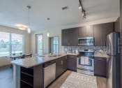 Thumbnail 1 of 41 - an open kitchen with stainless steel appliances and a granite counter top