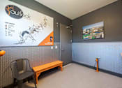Thumbnail 35 of 41 - A room with a map on the wall and a bench in front of it.