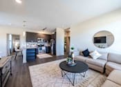 Thumbnail 4 of 41 - A modern living room with a black coffee table and a beige sofa.