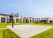 Thumbnail 21 of 26 - A large building complex with a flag flying in front of it.