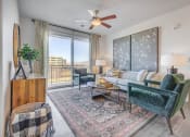 Thumbnail 5 of 47 - Furnished living room with hard floors and sliding glass door patio