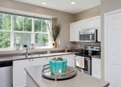 Thumbnail 24 of 44 - kitchen with breakfast bar at Lionsgate South, Hillsboro, OR