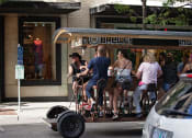 Thumbnail 40 of 44 - group of people pedal biking on booze tour through city at The Wyatt, Portland, Oregon