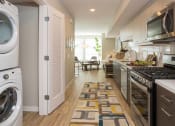 Thumbnail 5 of 30 - Model Kitchen to Living Room at AV8 Apartments in San Diego, CA