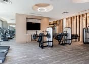 Thumbnail 41 of 82 - On-site 24-hour fitness center with tablet-integrated cardio machines at Vora Mission Valley, San Diego