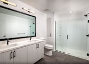 Thumbnail 27 of 42 - Bathroom with vanity, toilet, and shower.
