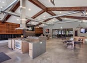 Thumbnail 26 of 35 - Cluhouse with demonstration kitchen, lounge seating, tables, fireplace, wall tv and a pool table