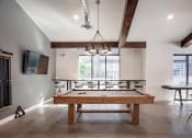 Thumbnail 29 of 35 - Clubhouse pool table, bar seating and wall tv