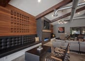 Thumbnail 28 of 35 - Clubhouse lounge seating, fireplace and wall tv close up