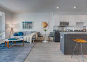 Thumbnail 12 of 35 - Model apartment home living room and kitchen from a different angle