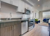 Thumbnail 16 of 35 - Model apartment home kitchen from different angle