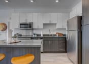 Thumbnail 9 of 35 - Model apartment home kitchen and island close up