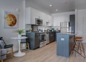 Thumbnail 10 of 35 - Model apartment home dining room and kitchen/island