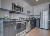 Thumbnail 11 of 35 - Model apartment home kitchen focusing on cabinents