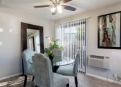 Thumbnail 24 of 26 - A dining room with a glass table and chairs at The Casas Apartments, San Diego