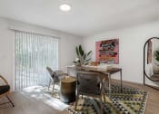 Thumbnail 10 of 23 - a desk with a chair and a table in a room with a sliding glass door