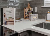 Thumbnail 4 of 23 - a kitchen counter with a sink and a book on the counter