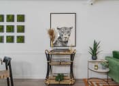 Thumbnail 9 of 23 - a home office with a desk and a leopard on the wall