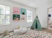 Thumbnail 12 of 23 - a bedroom with a teepee and pictures on the wall