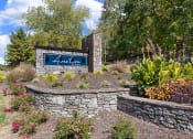 Thumbnail 23 of 23 - a stone retaining wall with a sign in front of it