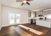 Thumbnail 38 of 60 - a kitchen and living room with a ceiling fan