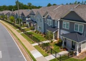 Thumbnail 1 of 60 - a row of houses on the side of a road