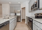 Thumbnail 41 of 60 - a kitchen with white cabinets and stainless steel appliances