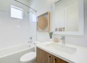 Thumbnail 45 of 47 - a bathroom with a sink and a toilet and a tub