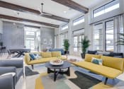 Thumbnail 17 of 47 - a living room with yellow couches and a table
