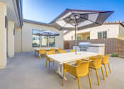Thumbnail 11 of 47 - a patio with a table and chairs and umbrellas