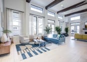 Thumbnail 16 of 47 - a living room with a blue couch and a rug