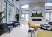 Thumbnail 18 of 47 - a living room with yellow chairs and a television