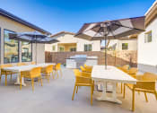 Thumbnail 10 of 47 - a patio with tables and chairs and umbrellas