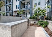 Thumbnail 24 of 31 - an outdoor hot tub with an apartment building in the background