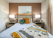 Thumbnail 6 of 31 - a bedroom with a bed and a painting on the wall