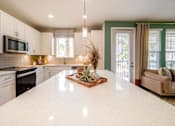 Thumbnail 14 of 31 - a kitchen with a large white counter top