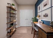 Thumbnail 23 of 31 - a home office with a desk and a door