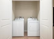 Thumbnail 8 of 31 - two washers and dryers in a laundry room with white doors