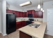 Thumbnail 1 of 32 - a kitchen with a black refrigerator and a sink