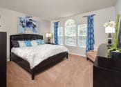 Thumbnail 5 of 32 - a bedroom with a bed and a large window