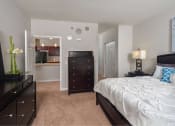 Thumbnail 6 of 32 - a bedroom with a bed and a dresser