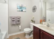 Thumbnail 7 of 32 - a bathroom with a toilet and a sink and a shower