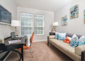 Thumbnail 8 of 32 - a living room with a couch and a table