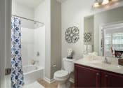 Thumbnail 9 of 32 - a bathroom with a shower toilet and sink