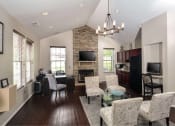 Thumbnail 12 of 32 - a living room and kitchen with a table and chairs
